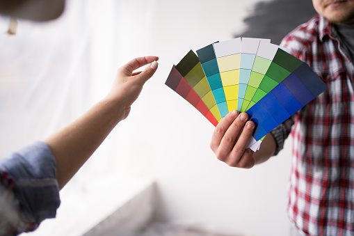 Couple looking at color samples at home. Repair home, interior design and renovation concept. Closeup