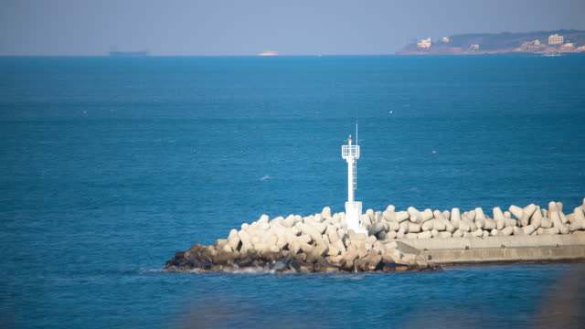Sea, lighthouse and seawall in winter / Pohang-si, Gyeongsangbuk-do, South Korea