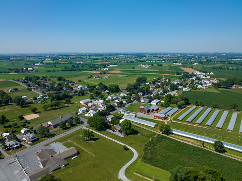 An Aerial View of Farmersville Pennsylvania surrounded by green fields in the summer.