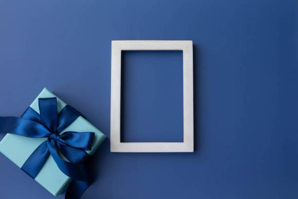 istock Image of blue ribbon with frame and gift in box, top view 1485338866