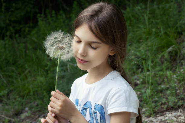 istock Girl and big dandelion in her hand 1485338913
