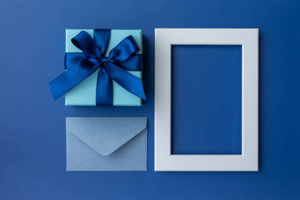 istock Image of blue ribbon with frame and gift in box, top view 1485338992
