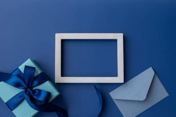 istock Image of blue ribbon with frame and gift in box, top view 1485339045