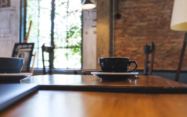 istock Two cups of coffee and a laptop computer on wooden table 1485339390