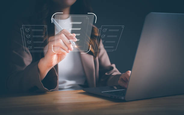 istock Businesswoman working on laptop with electronics document icons, using a stylus pen checking list on a digital tablet. electronic signature, signing, E-document management paperless workplace concept 1485344626