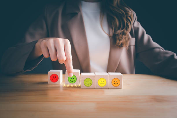 istock Customer hand holding wood block cube chooses a smile face. 5 Star satisfaction. Best excellent business services rating customer experience. Concept of Satisfaction survey, Feedback, Positive Review. 1485344668
