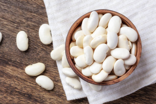 istock White beans in wooden bowl on line cloth 1485346360
