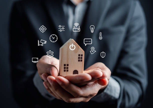 istock Smart home digital remote control on smartphone concept. internet of things in technology control. Businessman holding wooden house with virtual smart home icon function. 1485346975