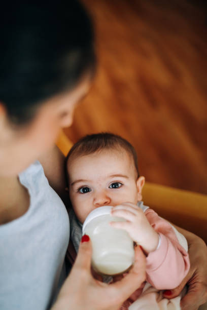 istock Mother Feeding Her Baby with milk 1485347644