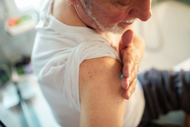 istock Senior man putting medical cream on his shoulder 1485347660