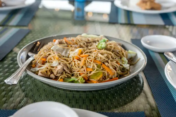 Photo of A large serving of Pancit Canton Guisado, a popular Filipino noodle dish.