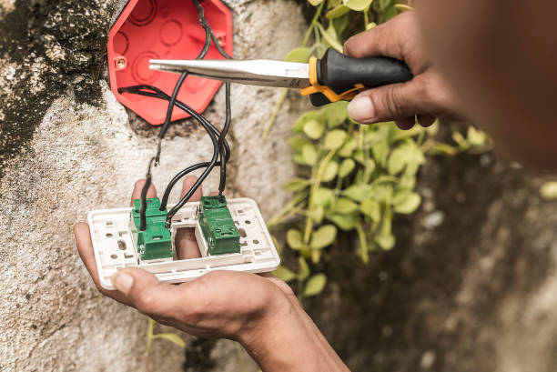 istock An electrician removes an old and defective electrical outlet from the concrete wall. Using pliers to cut the wires. 1485349003