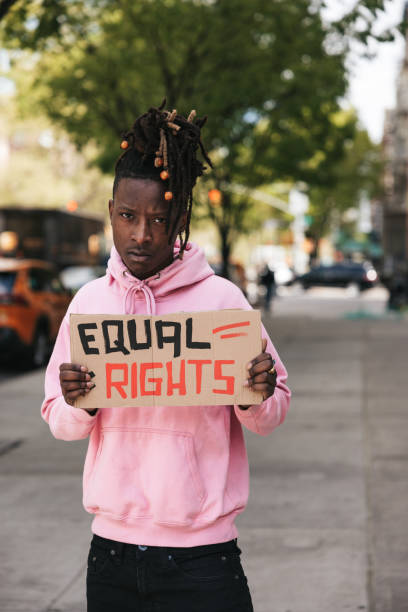 istock Young man portrait with a Equal rights sign on cardboard 1485349501