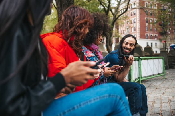 istock Group of friends sitting and scrolling mobile phone 1485350516