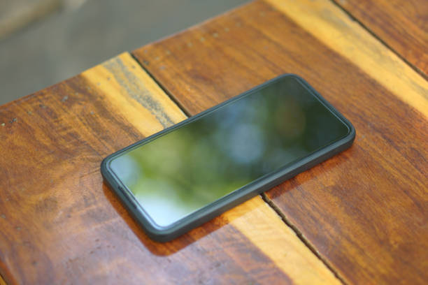 istock A black phone is placed on a brown wooden floor. 1485352566