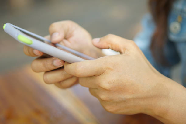 istock phone in woman hand using phone 1485352594