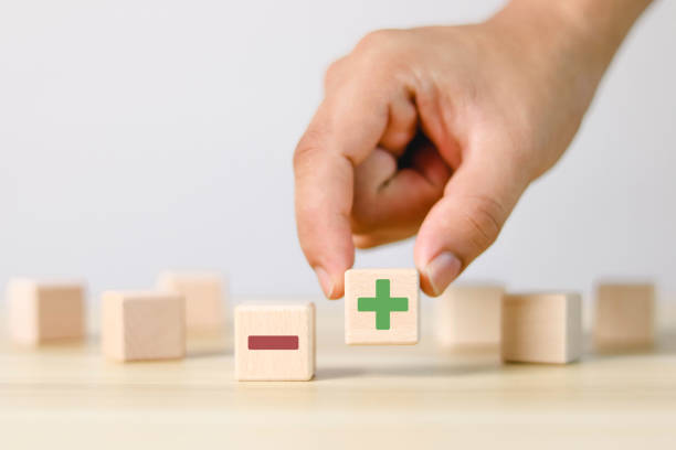 istock plus and minus signs on wooden blocks 1485353446