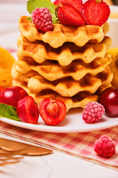 istock Stack of belgian waffles with fresh strawberries 1485355812