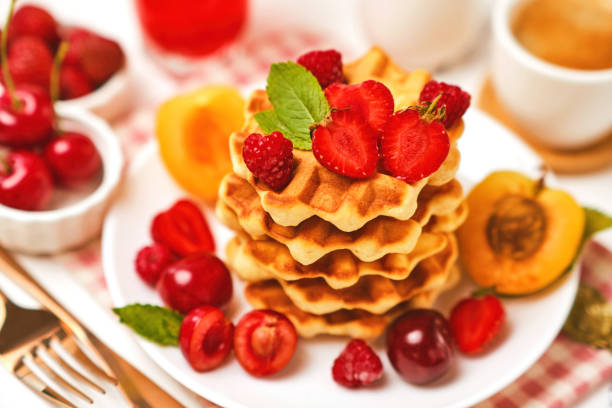 istock Belgian waffles with strawberries, apricots, cherries, juice 1485355844