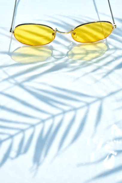 istock Summer flat lay with yellow sunglasses on water background 1485357738