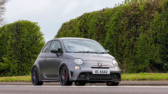 Bicester,Oxon,UK - April 23rd 2023. 2016 Fiat v500 ABARTH 695 car travelling on an English country road