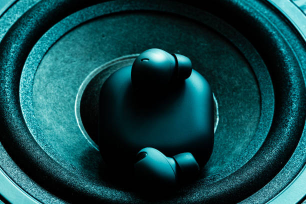 istock black wireless earpone buds on speakers background 1485359258