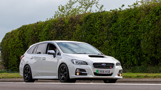 Bicester,Oxon,UK - April 23rd 2023. 2016 white Subaru Levorg car travelling on an English country road