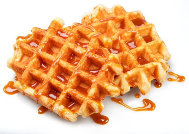 istock Belgian waffle with caramel topping isolated on white background. 1485363627