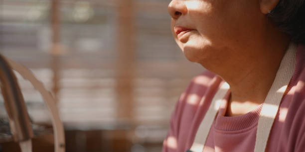 istock Asian mature woman absent-mindedly while washed a dishes in her hands 1485364668
