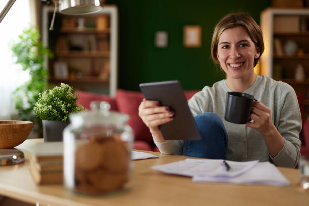 istock Women using digital tablet to check her finances at home office 1485365465