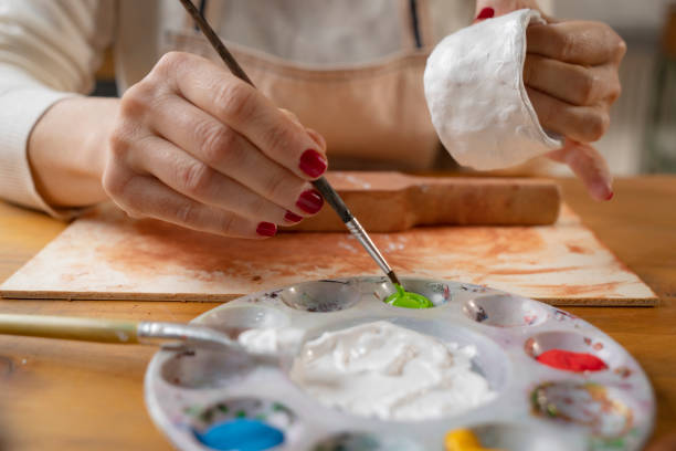 istock Female hands painting a pottery 1485367826