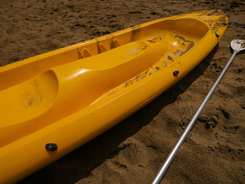a beautiful yellow canoe on the beach