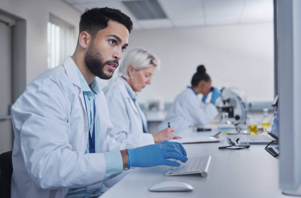 istock Typing, focus scientist working on computer in lab for medical search, innovation or science study in hospital. Medicine, internet or group of doctors on tech for healthcare or wellness DNA research 1485371863