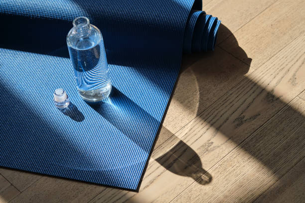 istock Reusable glass water bottle on yoga mat. 1485372018
