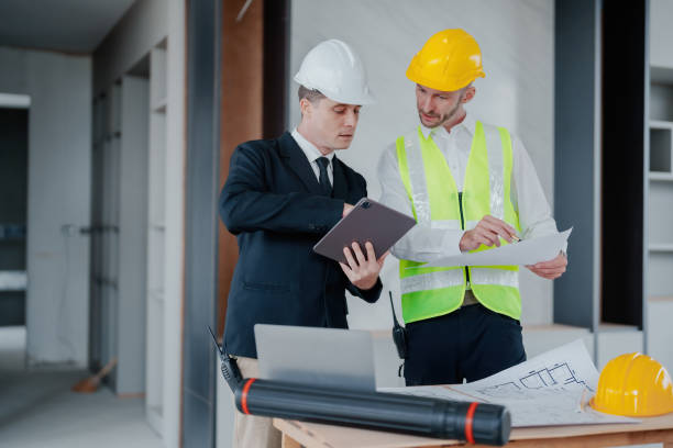 istock multi ethnic engineer brainstorming and measuring for cost estimating on blueprint and floor plan drawings about design architectural and engineering for houses and buildings 1485372059