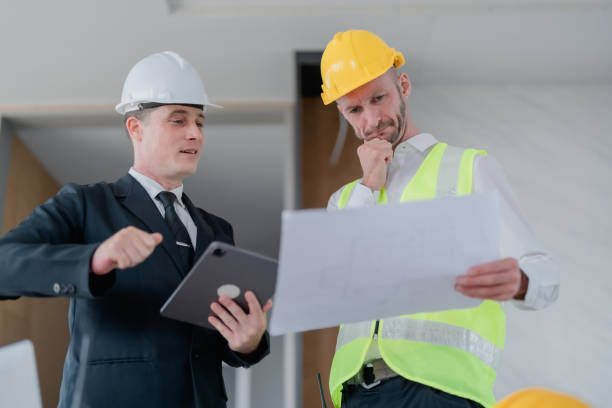 istock multi ethnic engineer brainstorming and measuring for cost estimating on blueprint and floor plan drawings about design architectural and engineering for houses and buildings 1485372448
