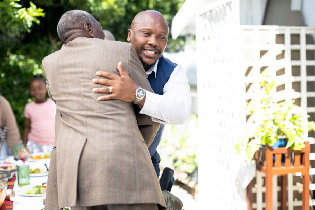 istock Grandfather hugs adult son 1485372564