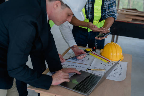 istock multi ethnic engineer brainstorming and measuring for cost estimating on blueprint and floor plan drawings about design architectural and engineering for houses and buildings 1485372581