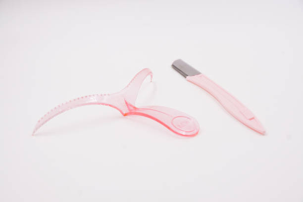 istock Pink eyebrow template shaping tool with eyebrow razor 1485375632