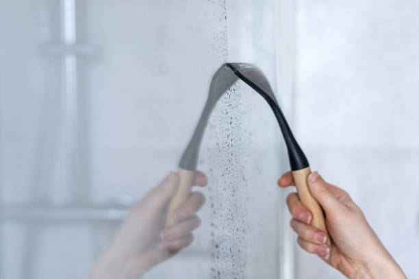 istock Glass squeegee erase drops and dirt on shower partition 1485375688