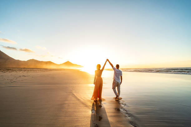 istock Lovely, romantic couple walking on sunset beach, enjoying evening light, relaxing on tropical summer vacation. 1485379320