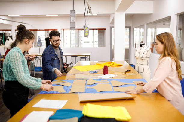 istock Students tracing clothing patterns on fabric in a fashion course 1485379542