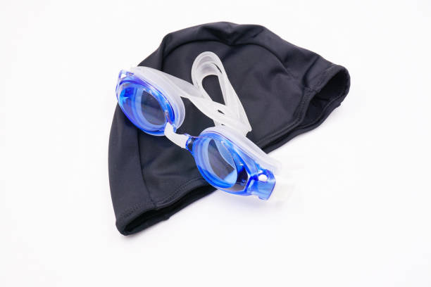 Blue swimming goggles and black swimming cap