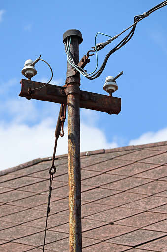 Old electricity and telephone cable on a roof