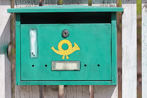 Very high resolution 3D rendering of an open mailbox with a letter arriving.