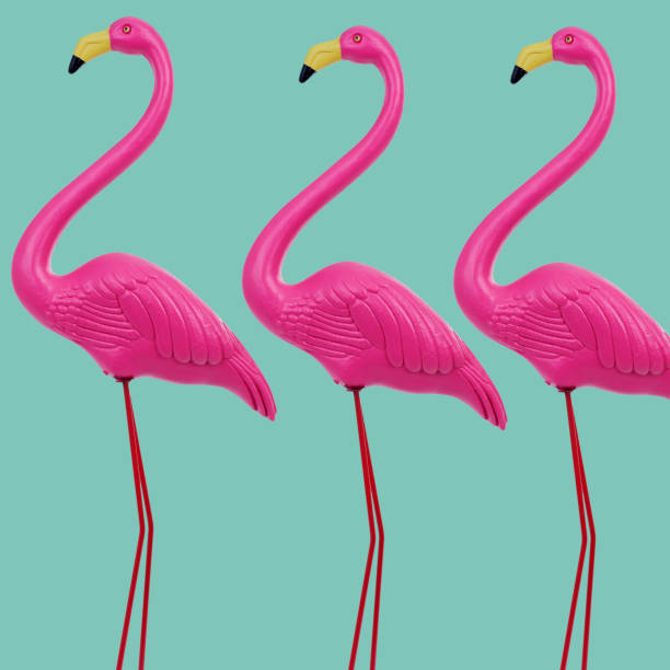 istock three standing fake pink flamingos 1485384064