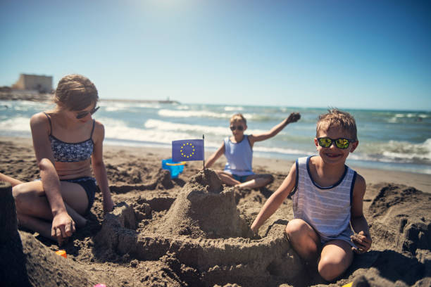 istock Three kids are building a sandcastle on beach 1485384071
