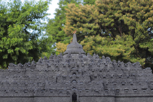 Taman Mini Indonesia Indah - Jakarta, January 12, 2022. Miniature of Borobudur Temple with sparrows perched on it