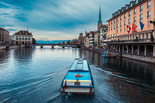 View of Zurich old town with passenger boat on Limmat river