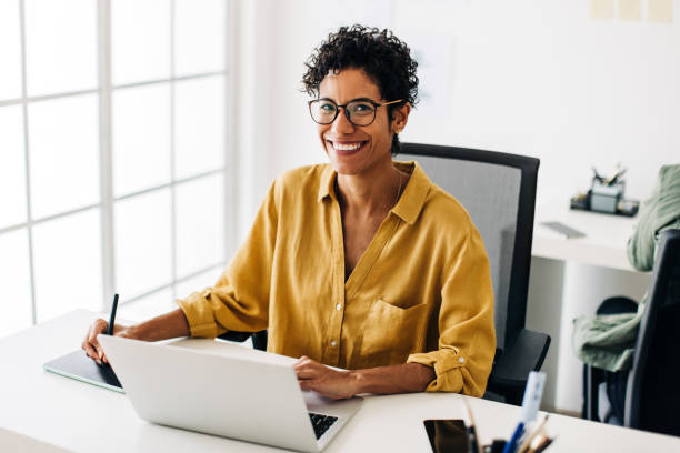 istock Female graphic designer working at her desk in an office 1485394170